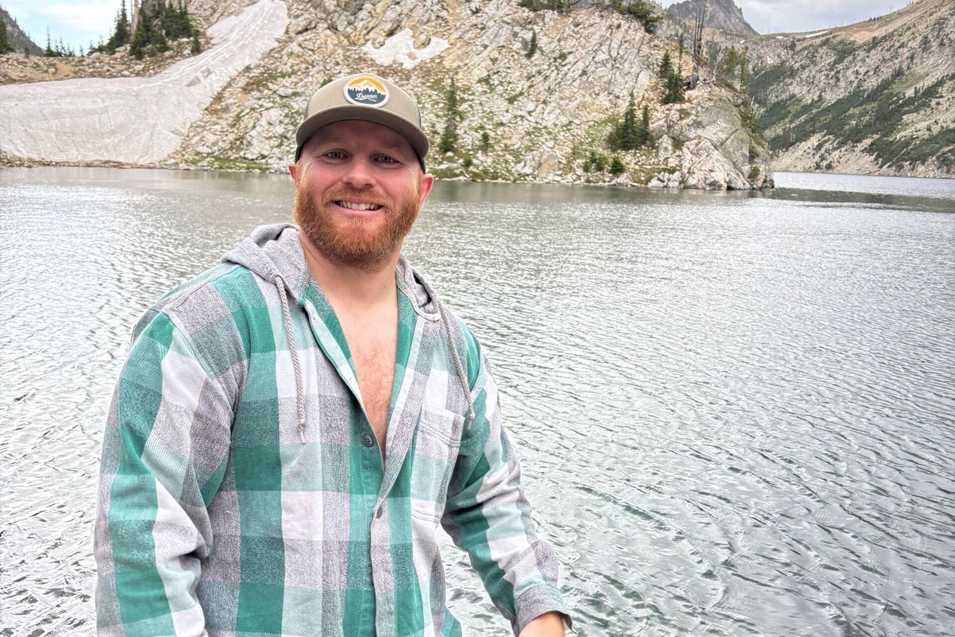 Nathan Danner in front of a lake taking a vacation from real estate 