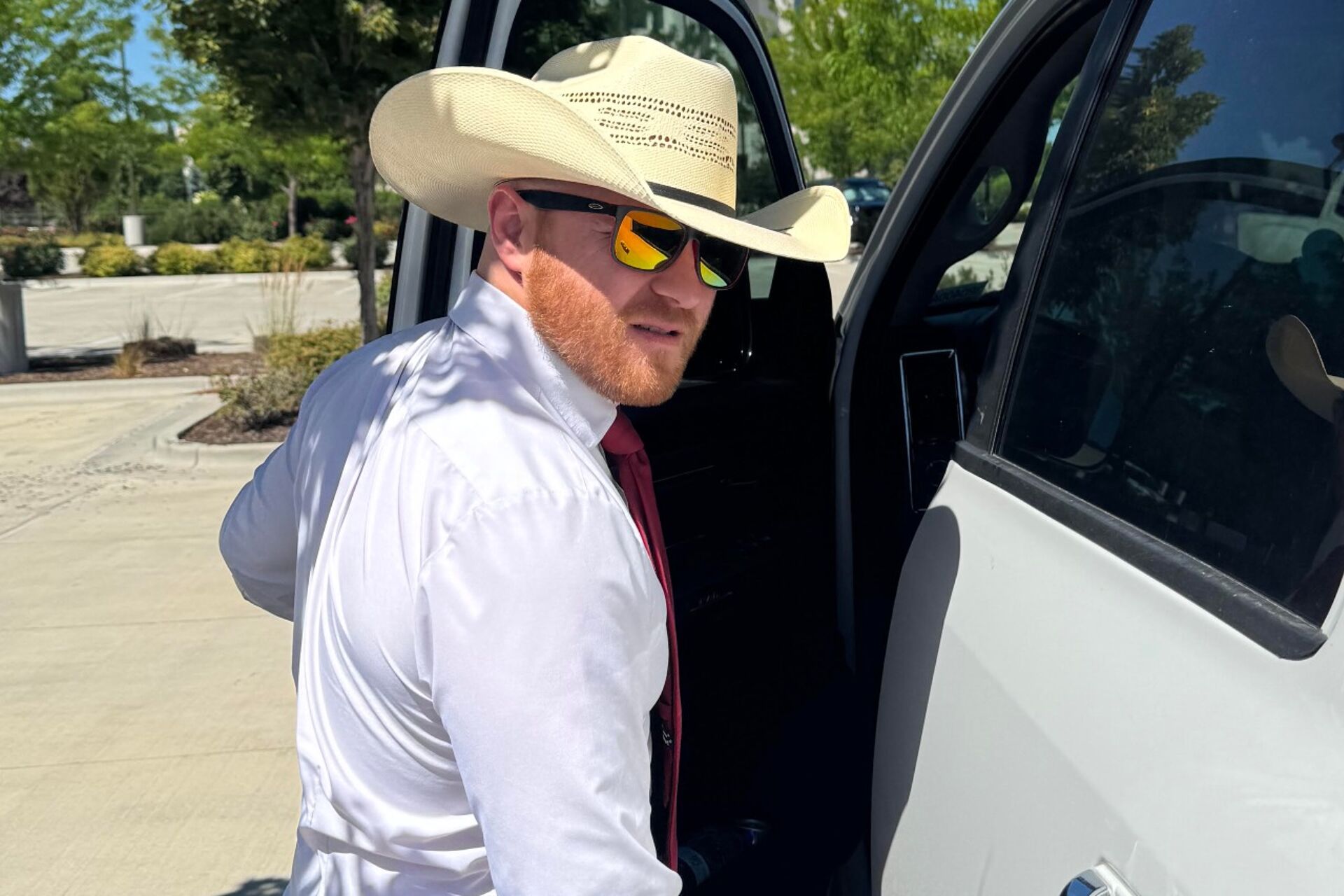Nathan Danner wearing a cowboy hat getting into his truck to look at real estate